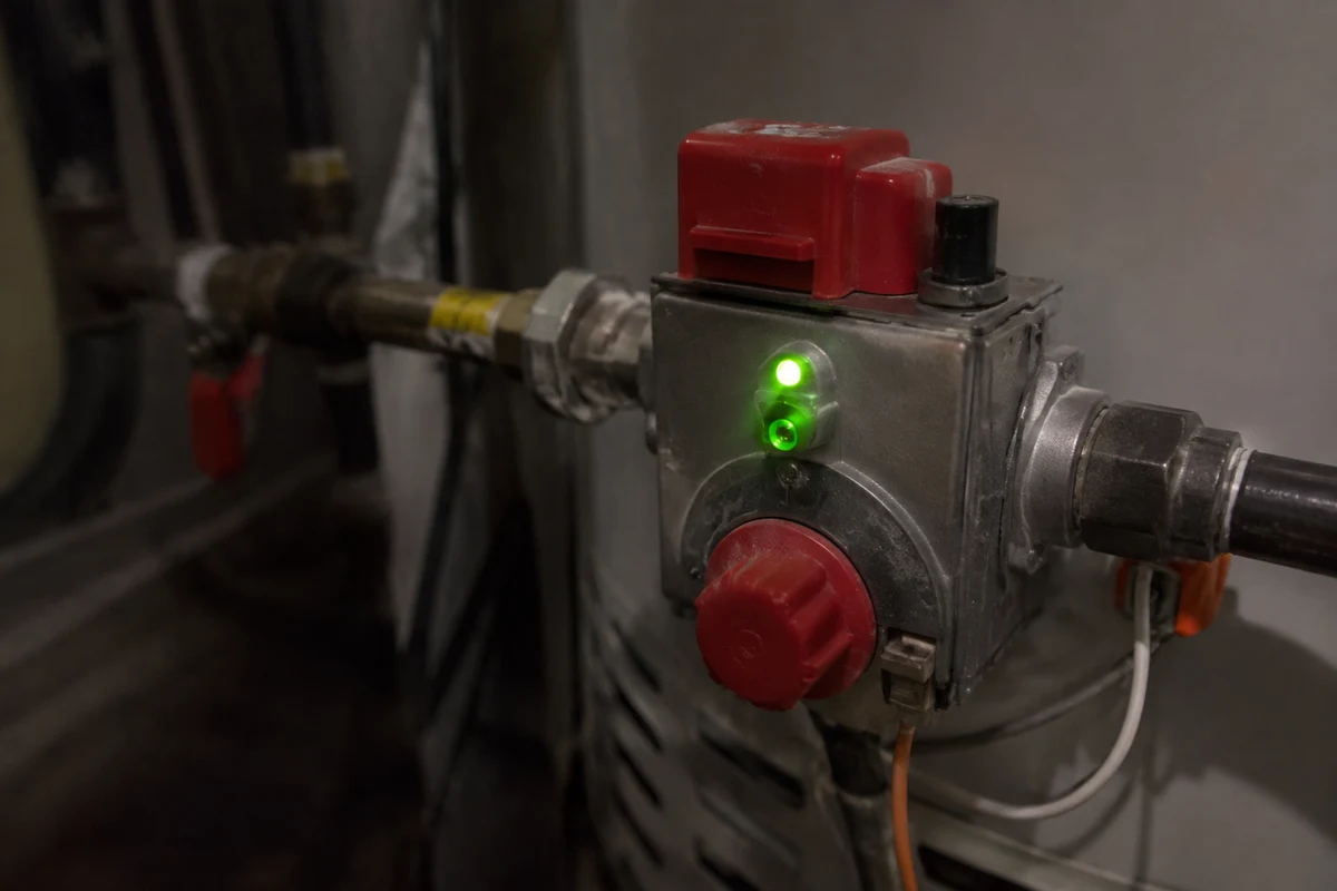A.O. Smith gas control valve with a green status light on the front of a water heater